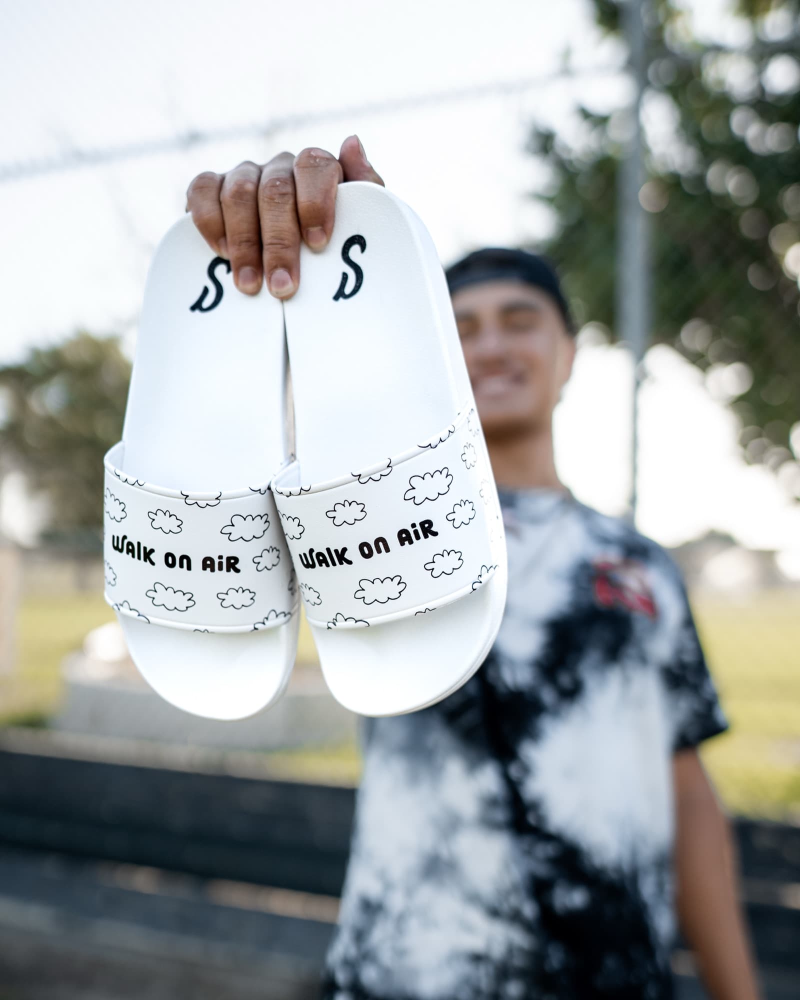 Athlete holding up a pair of Slidez