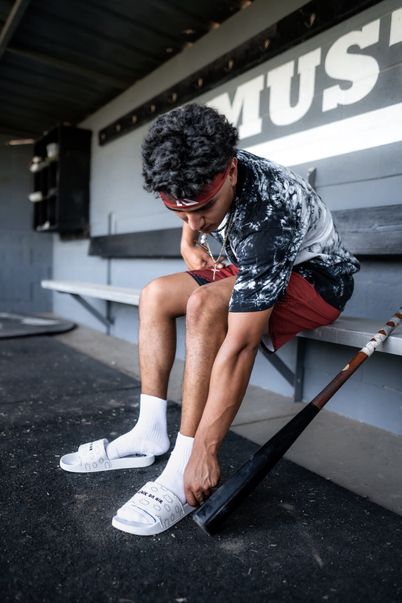 Athlete putting on Slidez in a baseball dugout